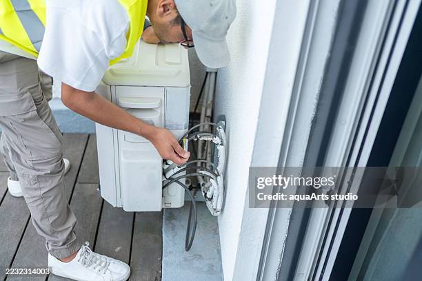 maintenance service for air conditioning outdoor unit - pipe replacement stock pictures, royalty-free photos & images
