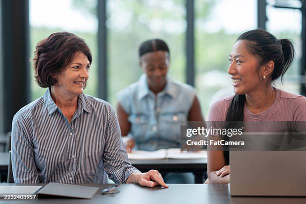 diverse group of adults collaborating in a modern educational setting - nontraditional student stock pictures, royalty-free photos & images