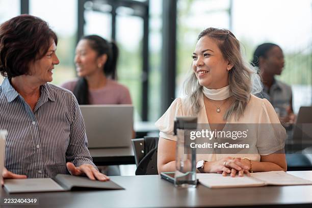 group of diverse individuals engaging in a collaborative learning session - new skill stock pictures, royalty-free photos & images