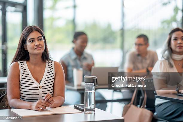 focused students engaged in learning during an interactive classroom session - neurodiversity stock pictures, royalty-free photos & images