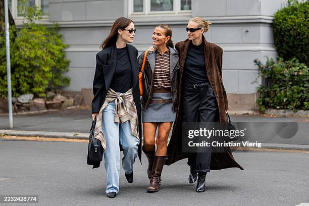 Annabel Rosendahl wears black coat, denim jeans, bag & Janka Polliani wears leather jacket, grey skirt, orange Hermes bag with Labubu puppet & Tine...