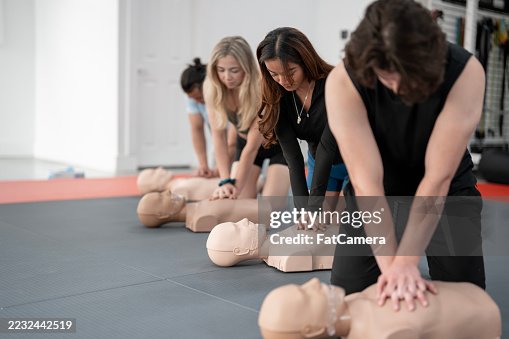 Group Practicing CPR Techniques on Mannequins During a Classroom Training Session Group Practicing CPR Techniques on Mannequins During a Classroom Training Session