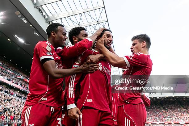 Dominik Szoboszlai of Liverpool celebrates with his teammates after scoring his sides first goal to make it 1 - 0 during the Premier League match...