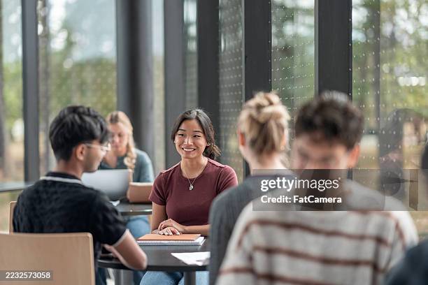 group of diverse students collaborating in a modern study environment - post secondary education stock pictures, royalty-free photos & images