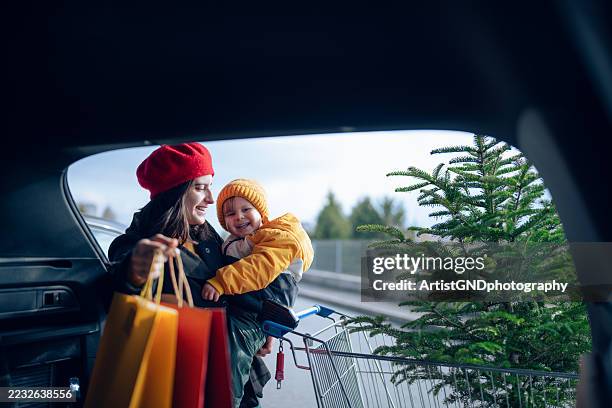 happy holiday spirit after a christmas shopping with my little boy. - family car christmas imagens e fotografias de stock