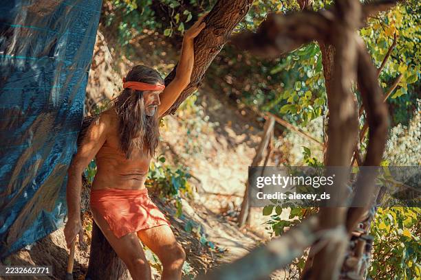 historical reenactment of a prehistoric human in his natural environment - prehistoric era stock pictures, royalty-free photos & images