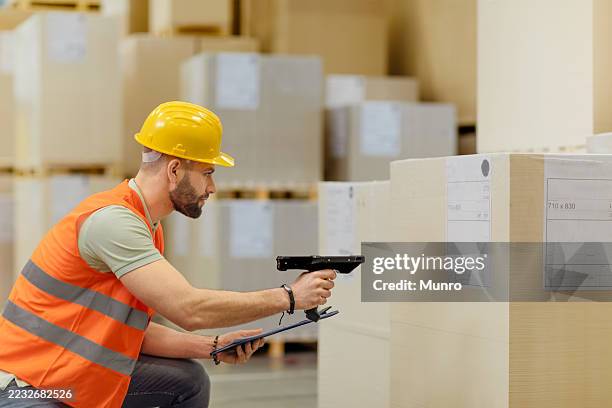 worker in warehouse using bar code scanner - bar code reader stock pictures, royalty-free photos & images