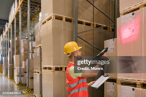 Worker in warehouse using bar code scanner Worker in warehouse using bar code scanner