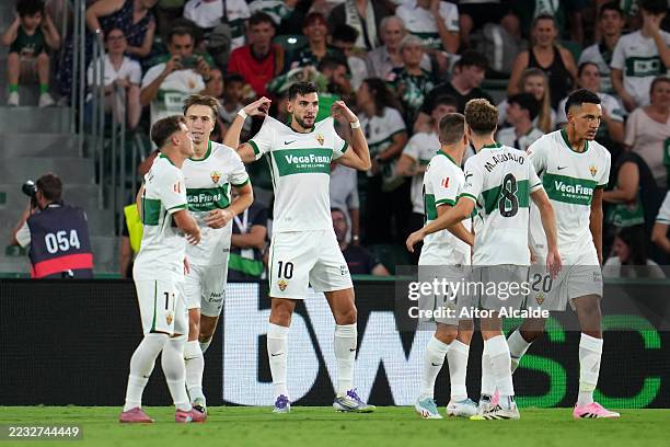 Rafa Mir of Elche CF celebrates scoring his team's first goal with team mates during the LaLiga EA Sports match between Elche CF and Levante UD at...