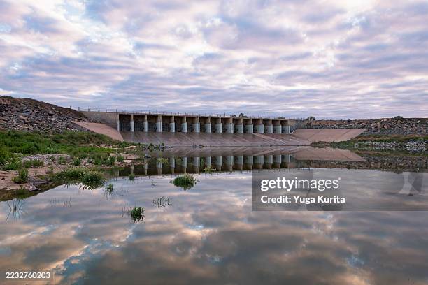 menindee lakes dam wall with dramatic sky reflection - murray darling basin stock pictures, royalty-free photos & images