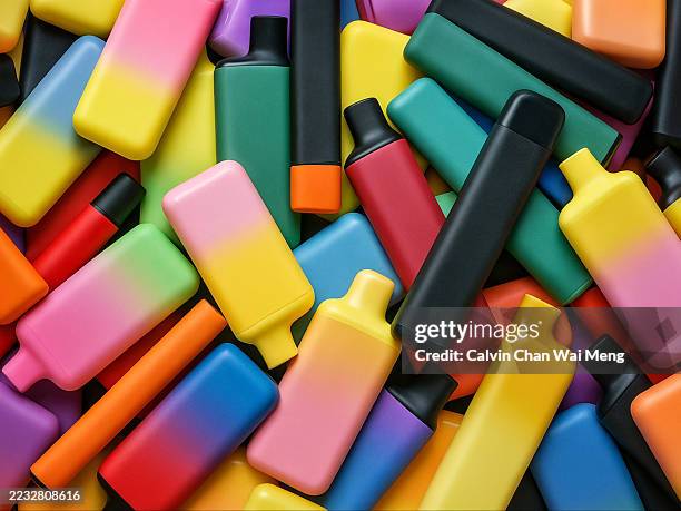 a heap of colorful electronic vaporizer or e-vaporizer aka electronic cigarettes or vapes - electronic cigarette stock pictures, royalty-free photos & images
