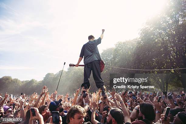Jean-Noël Scherrer of the French rock band Last Train crowd surfs during their set at Rock en Seine at Domaine National de Saint-Cloud on August 24,...