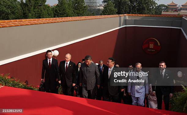 China's President Xi Jinping , North Korea's leader Kim Jong Un and Russia's President Vladimir Putin arrive for a reception in the Great Hall of the...