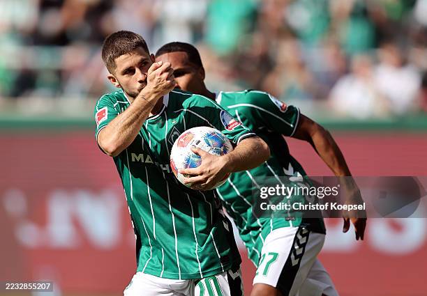 Romano Schmid of Werder Bremen celebrates after scoring his team's first goal from the penalty spot during the Bundesliga match between SV Werder...