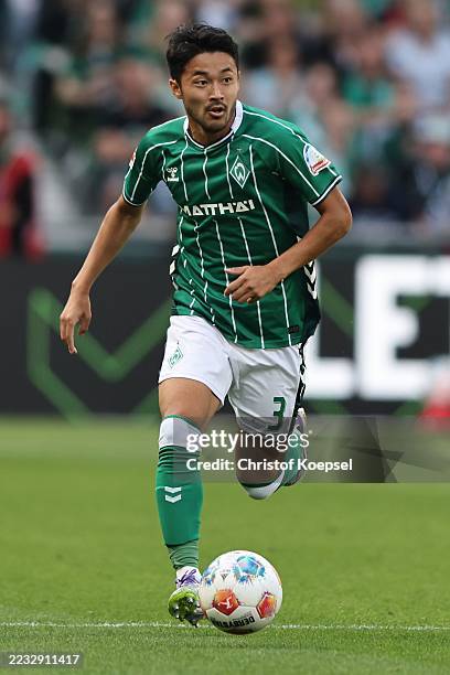 Yukinari Sugawara of SV Werder Bremen runs with the ball during the Bundesliga match between SV Werder Bremen and Bayer 04 Leverkusen at Weserstadion...
