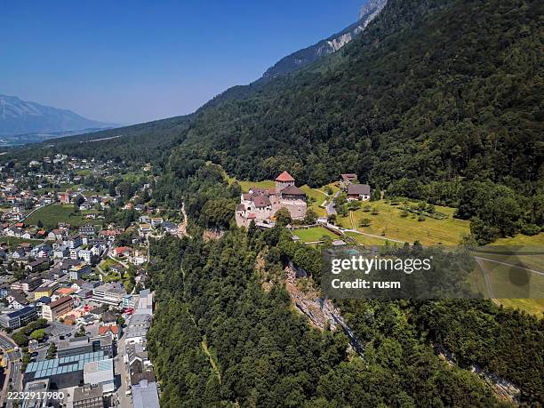 flight over of vaduz town and castle in liechtenstein - vaduz stock pictures, royalty-free photos & images