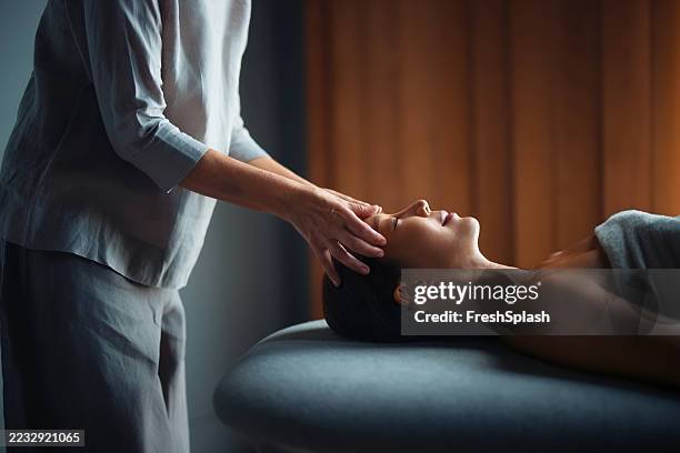 professional head massage therapy in a relaxing spa environment - spa bildbanksfoton och bilder