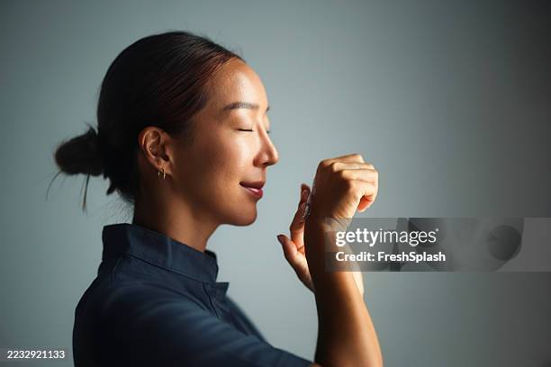 profile of serene woman engaged in a calming mindfulness practice - low lighting stock pictures, royalty-free photos & images