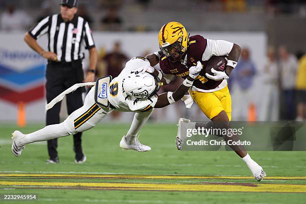 Defensive back Canyon Moses of the Northern Arizona Lumberjacks tackles running back Kyson Brown of the Arizona State Sun Devils during the first...