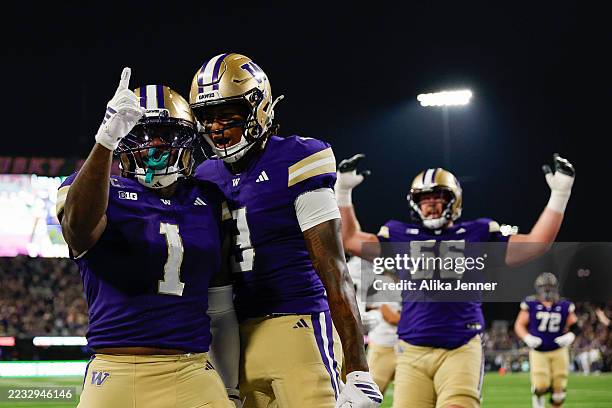 Jonah Coleman of the Washington Huskies celebrates with teammates after scoring a touchdown during the first quarter of the game against the Colorado...
