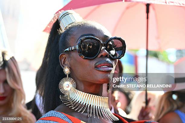 Guests queue to attend the red carpet for the movie "Nuhai" presented in competition at the 82nd International Venice Film Festival, at Venice Lido...