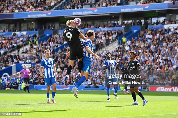 Erling Haaland of Manchester City heads the ball as he clashes with Maxim De Cuyper of Brighton & Hove Albion during the Premier League match between...