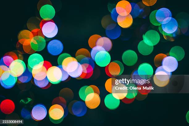 vibrant bokeh lights in an array of multicolored patterns on dark background - aura colour stock pictures, royalty-free photos & images
