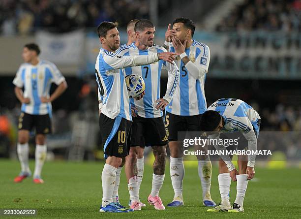 Argentina's forward Lionel Messi gestures next to teammates midfielder Rodrigo De Paul, midfielder Leandro Paredes and midfielder Thiago Almada...