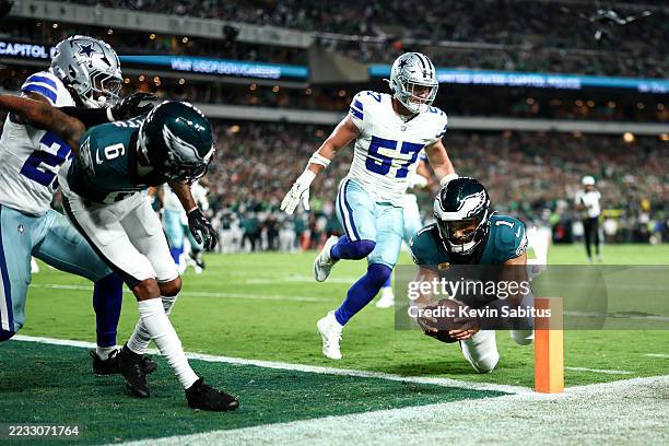 Jalen Hurts of the Philadelphia Eagles dives to the end zone to score a touchdown during the first half of an NFL football game against the Dallas...