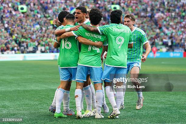 Osaze de Rosario of Seattle Sounders FC celebrates with teammates after scoring the team's first goal during the Leagues Cup Final match between...