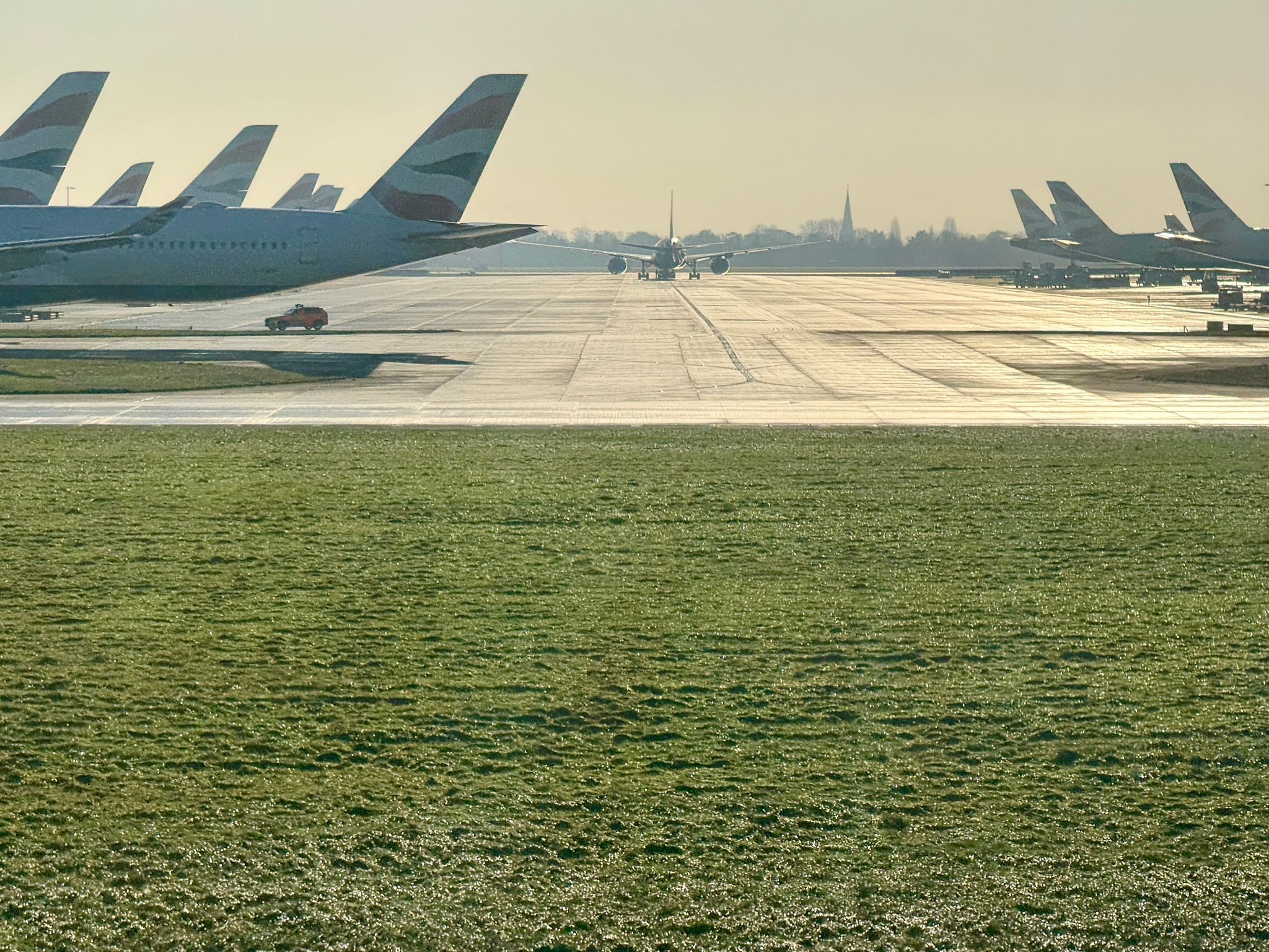 British Airways Aircraft on Runway with Distant Spire British Airways Aircraft on Runway with Distant Spire