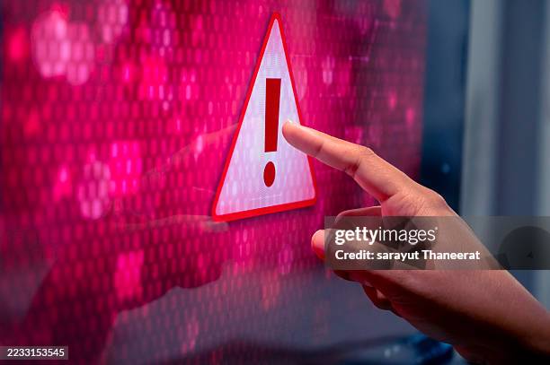 cybersecurity warning alert with digital code and network connections. a digital cybersecurity warning icon with an exclamation mark, displayed over computer code and connected network nodes, symbolizing data security threats and online risk alerts. - error message stock pictures, royalty-free photos & images