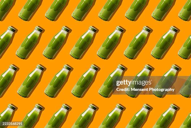 smoothie and juice bottles pattern on yellow background - detox stock pictures, royalty-free photos & images