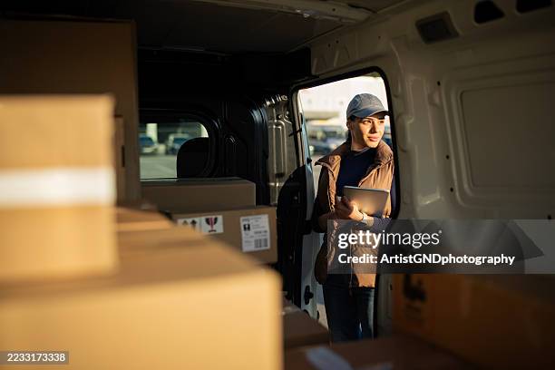delivery worker searching for parcel in delivery van. - hemleverans bildbanksfoton och bilder