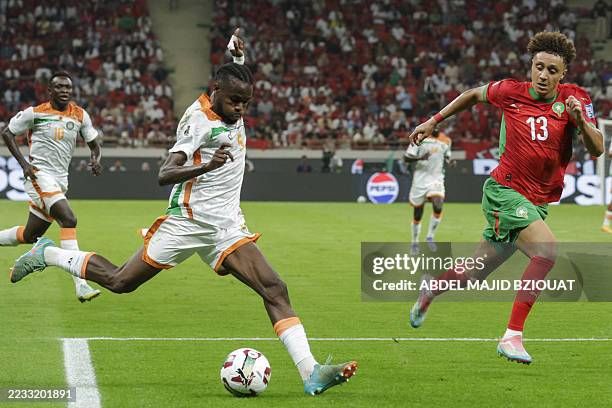 Niger's defender Abdoul Garba prepares to pass the ball while marked by Morocco's forward Eliesse Ben Seghir during the FIFA World Cup 2026 Group E...