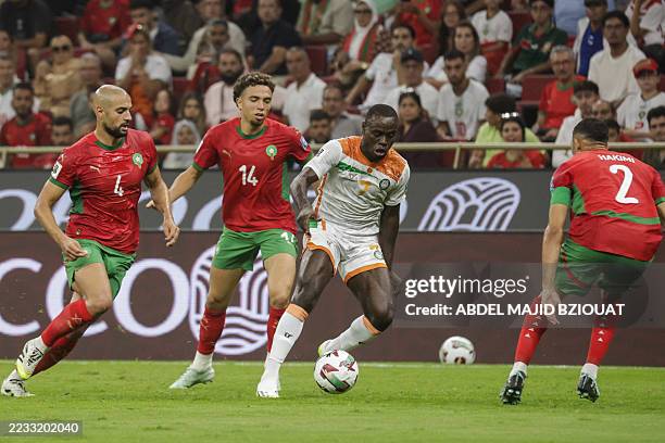 Niger's forward Daniel Sosah is marked by Morocco's players during the FIFA World Cup 2026 Group E African qualification football match between...
