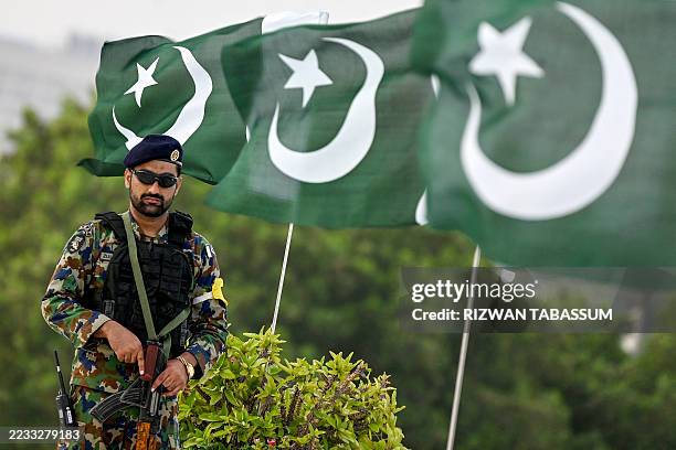 Uqaab Force commando and Air Force personnel stands guard outside the mausoleum of Pakistan's founding father Muhammad Ali Jinnah in Karachi on...