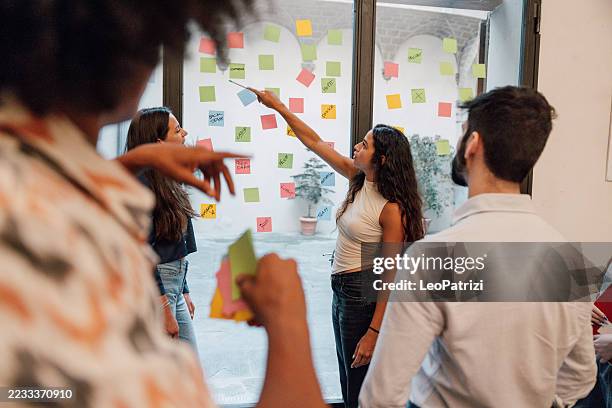 collaborative brainstorming with sticky notes in a modern workspace - papel adesivo imagens e fotografias de stock