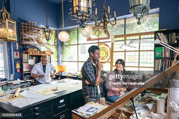 wide shot of a team of architects working in the studio on a home renovation project - design studio stock pictures, royalty-free photos & images