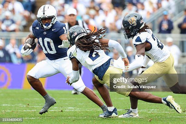 Nicholas Singleton of the Penn State Nittany Lions reaches out to stiff arm Brian Blades II of the FIU Panthers during the first quarter at Beaver...