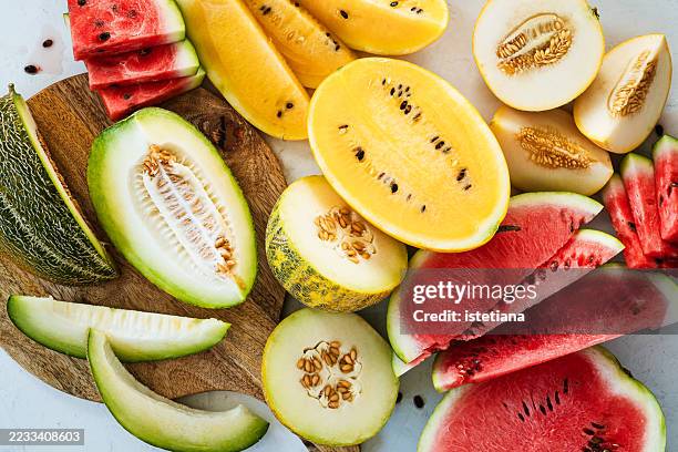 melon varieties, fresh summer fruits background - melon stock pictures, royalty-free photos & images