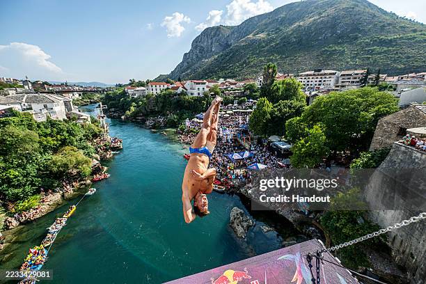 In this handout image provided by Red Bull, Constantin Popovici of Romania dives from the 27.5 metre platform on Stari Most during the final...
