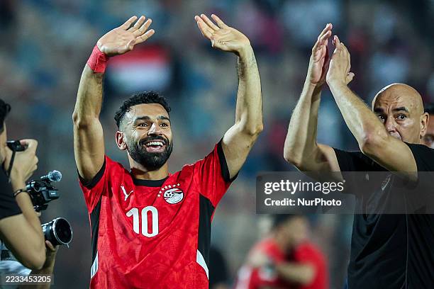 Mohamed Salah and Head Coach Hossam Hassan of Egypt stand together after the FIFA World Cup African qualifiers match Group A between Egypt and...