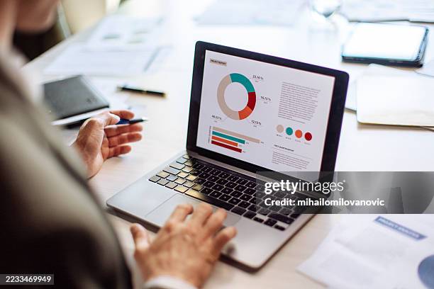 business professional reviewing analytical data on a laptop during a work meeting - collection stock pictures, royalty-free photos & images