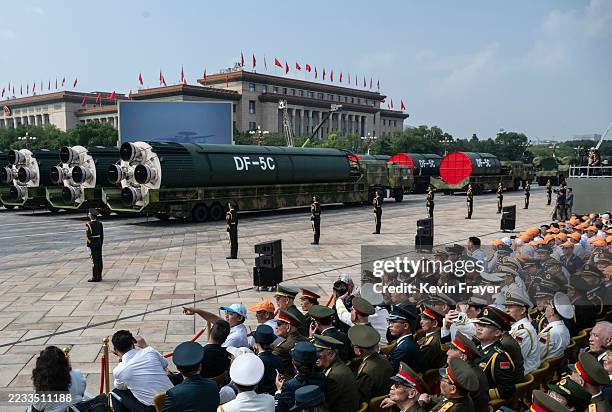 The new DF-5C global covering strategic nuclear capable missiles are seen on trucks as it is debuted at a military parade marking the 80th...