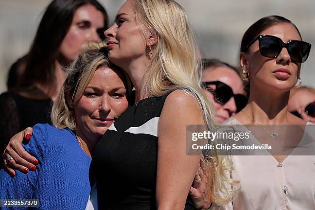 Anouska De Georgiou embraces Danielle Bensky as Marina Lacerda looks on during a news conference with fellow alleged victims of disgraced financier...