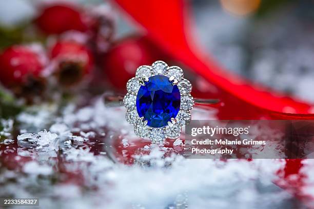 sapphire and diamond ring, on red ribbon - sapphire stock pictures, royalty-free photos & images