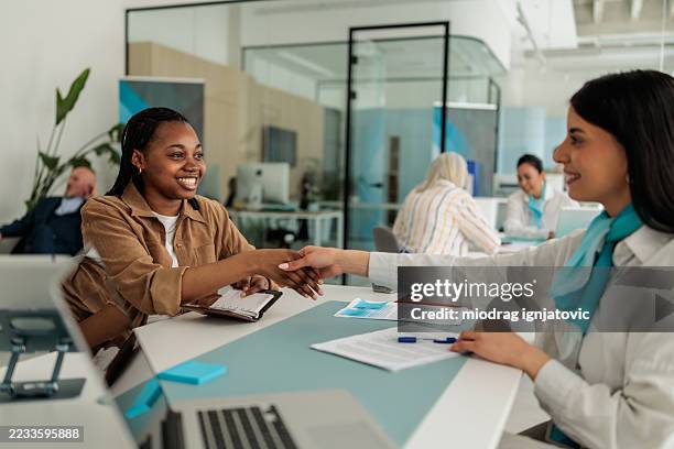 female financial advisor closing deal with client - bank branch stock pictures, royalty-free photos & images