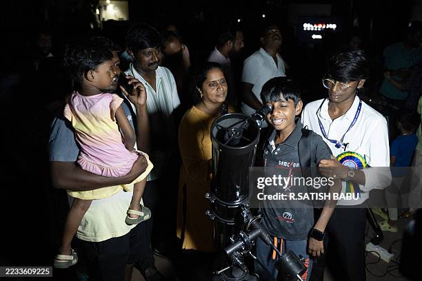 Boy looks at the Blood Moon through a telescope during a total lunar eclipse visible across Asia and swathes of Europe and Africa in Chennai on...