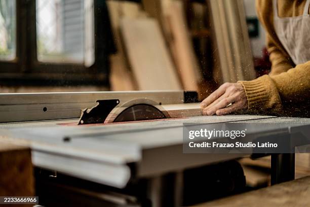 close-up of a carpenter using a table saw in a workshop - table saw stock pictures, royalty-free photos & images